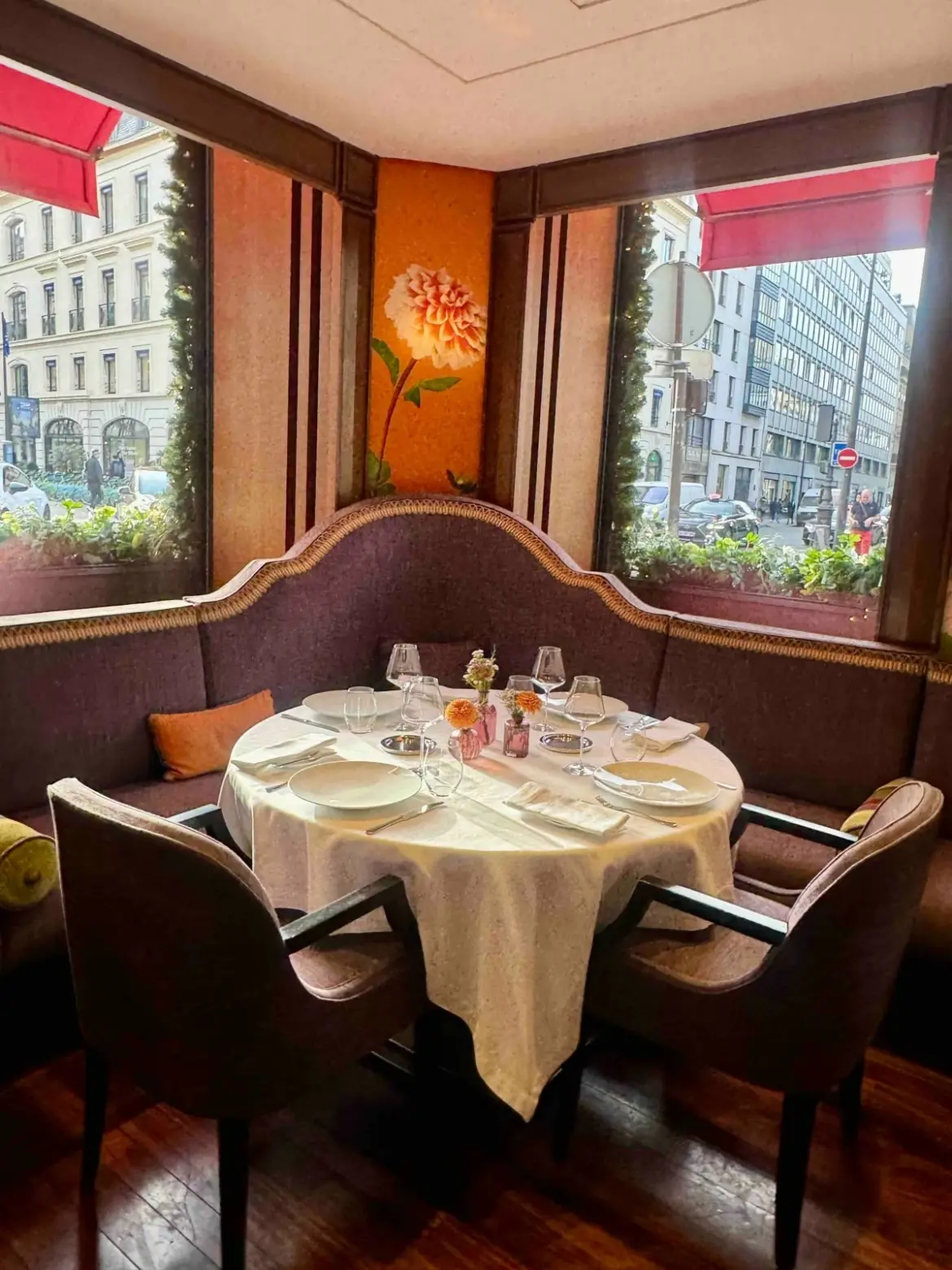 PARISIAN WARMTH  Autumn-toned interiors with plush purple seating, bold floral wall art and soft, precise lighting.