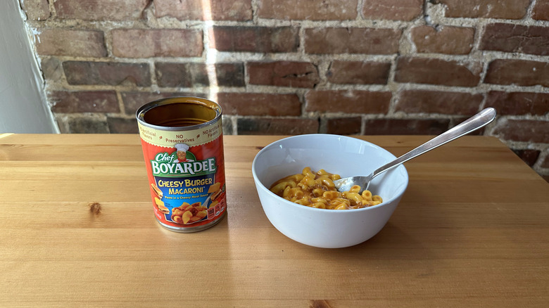 Cheesy Burger Macaroni with spoon on wooden table
