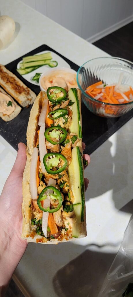 Homemade banh mi with a side of onion rings