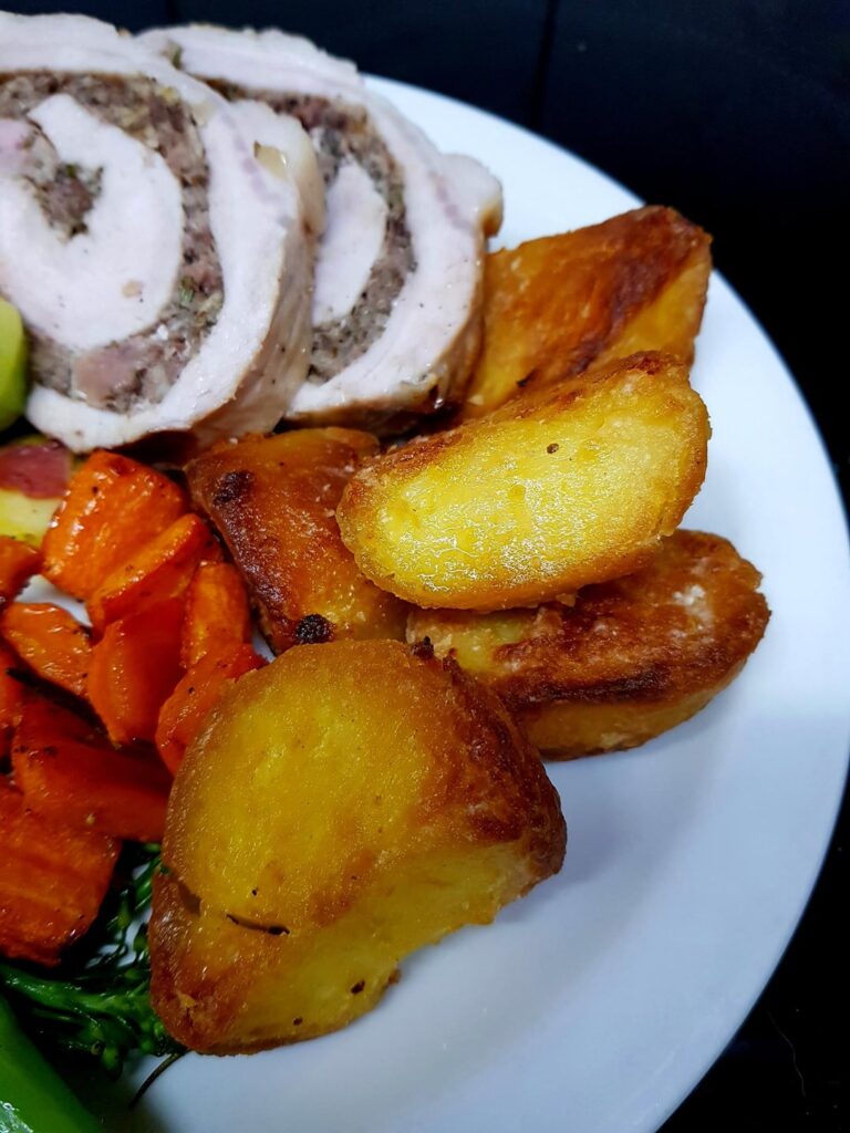 Belated Roast - Rolled and Stuffed Pork, Goose Potatoes, Garlic Carrots, Sautéed Sprouts w/ Bacon and Buttery Tenderstems. White Wine Mustard Gravy.