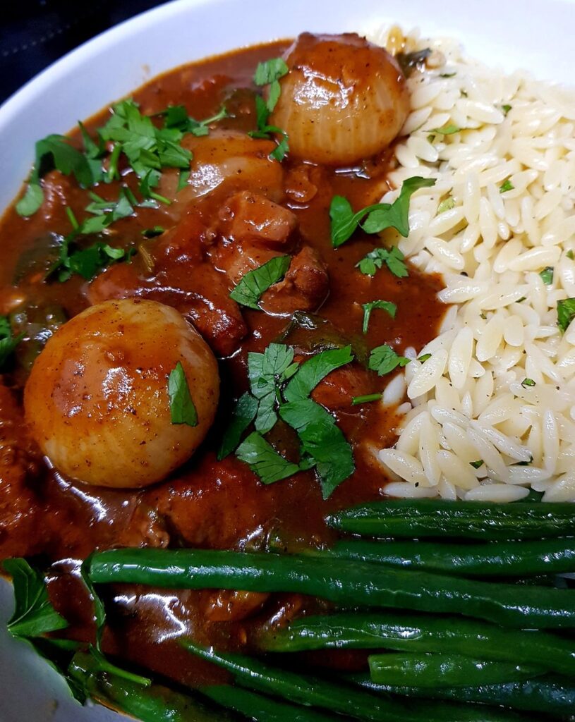 Greek Stifado with Pork Shoulder. Served with Orzo Pasta and Sautéed Green Beans.