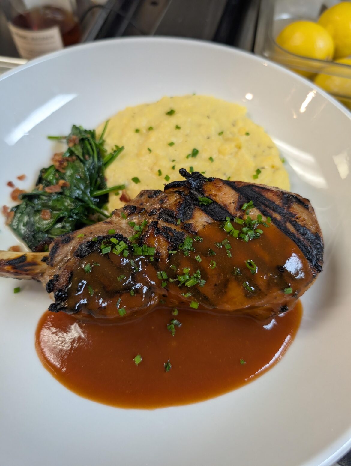 Grilled pork chop, polenta and spinach.