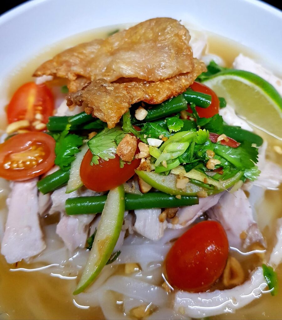 Alvin Quah's Famous Drunken Chicken. Chicken Poached in Shaoxing and Finished with Chilled Smashed Salad and Nuts. With Glass Noodles and Crispy Skin.
