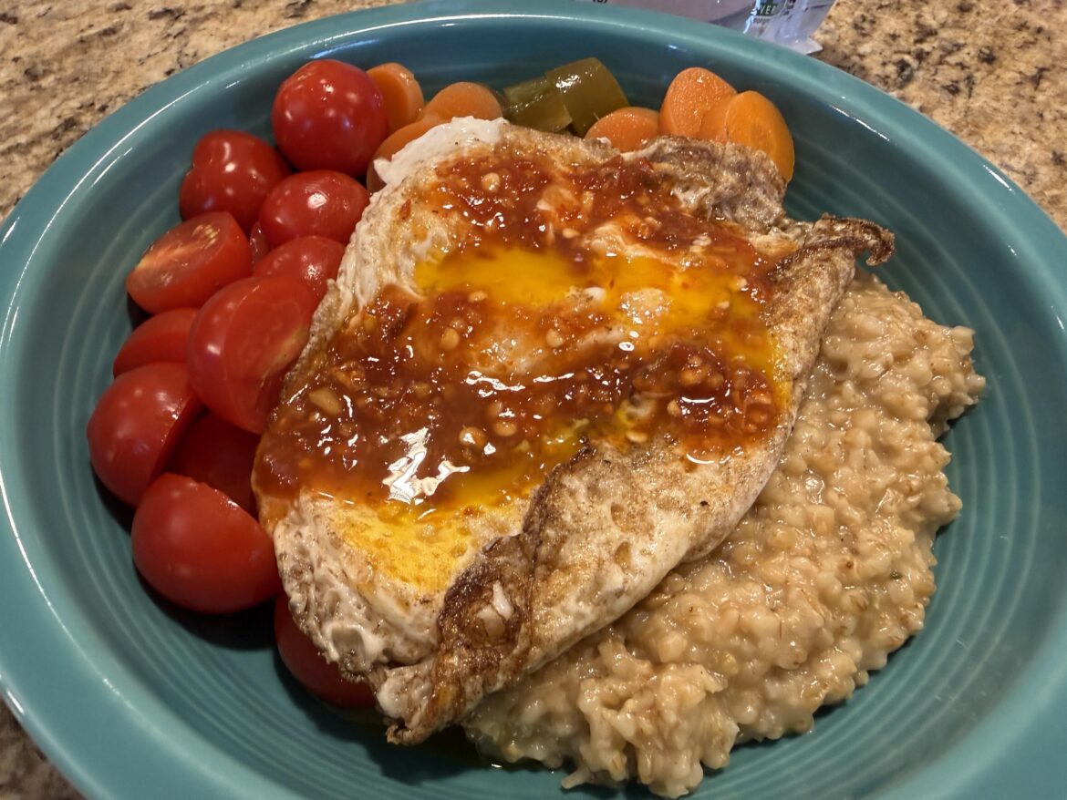 Steel Cut Oats cooked in chicken stock, pickled jalapeño/carrot, cherry tomato, sambal, and fried eggs.