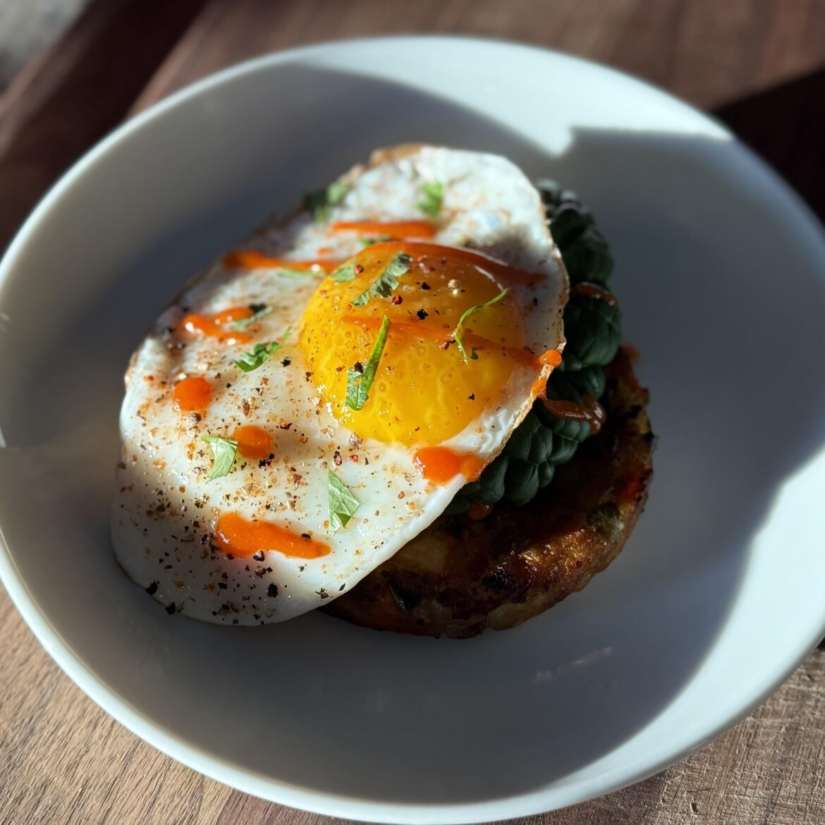 Sunny side up egg over greens and veggie masala patty - 218 cals