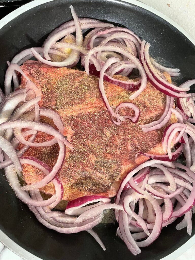 Steak, onions, and a lemon.