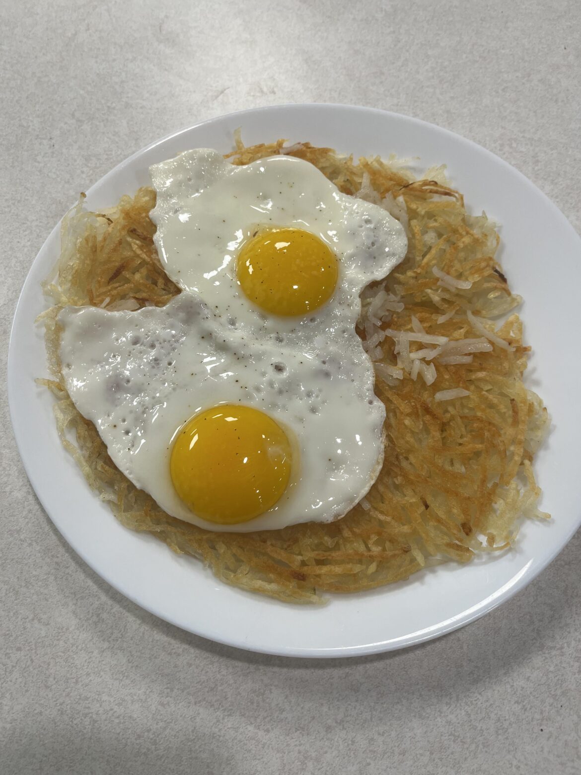 Put some sunny side eggs on homemade shredded hash browns