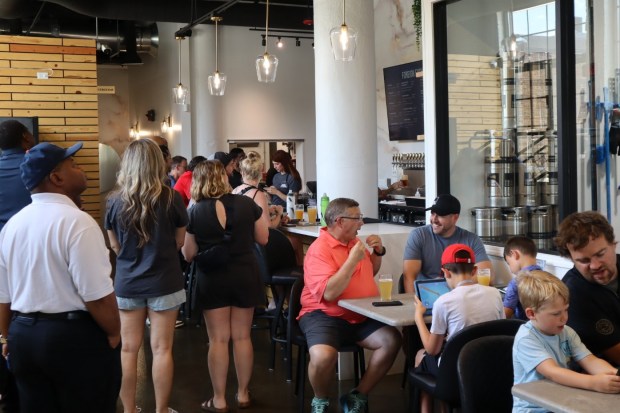 After the grand opening of Foreign Exchange in downtown Aurora on Wednesday, people pack the brewpub to get a taste of the company's offerings. (R. Christian Smith / The Beacon-News)