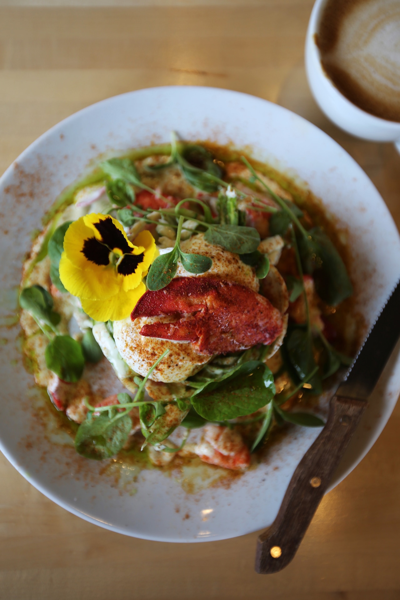 An overhead view of a plate of food with a latte .