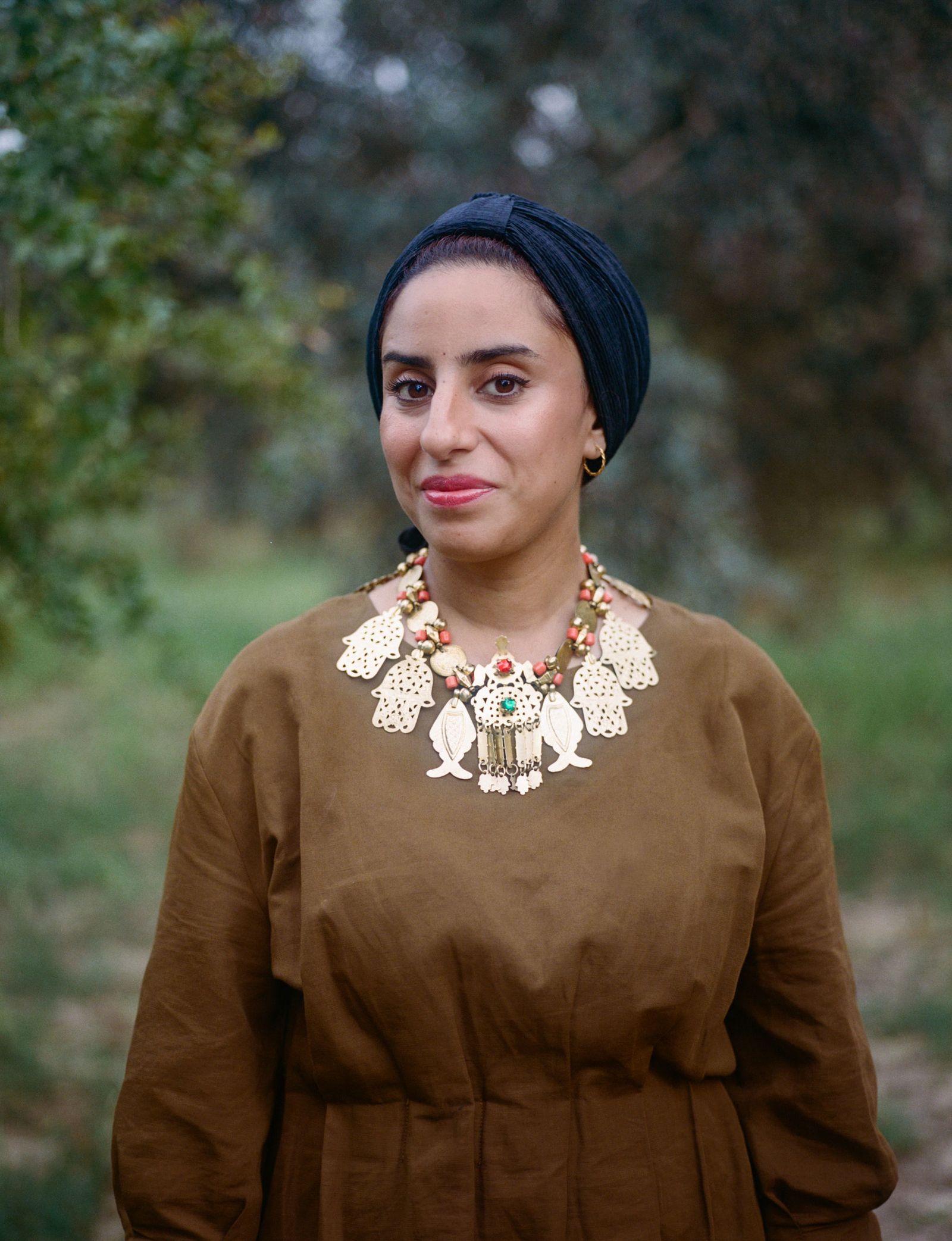 Image may contain Adult Person Black Hair Hair Accessories Jewelry Necklace Head and Face