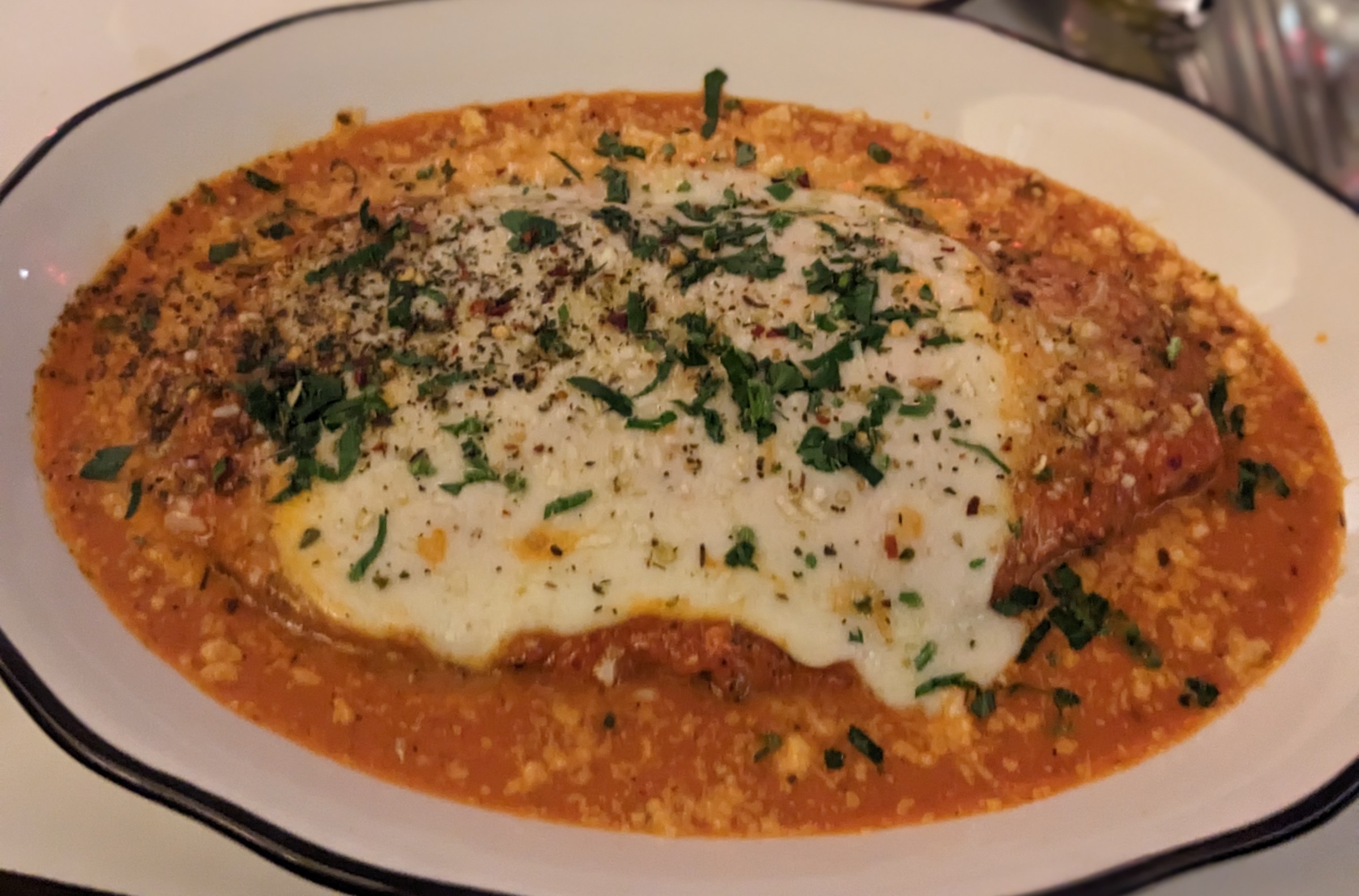 Meat surrounded with tomato sauce.