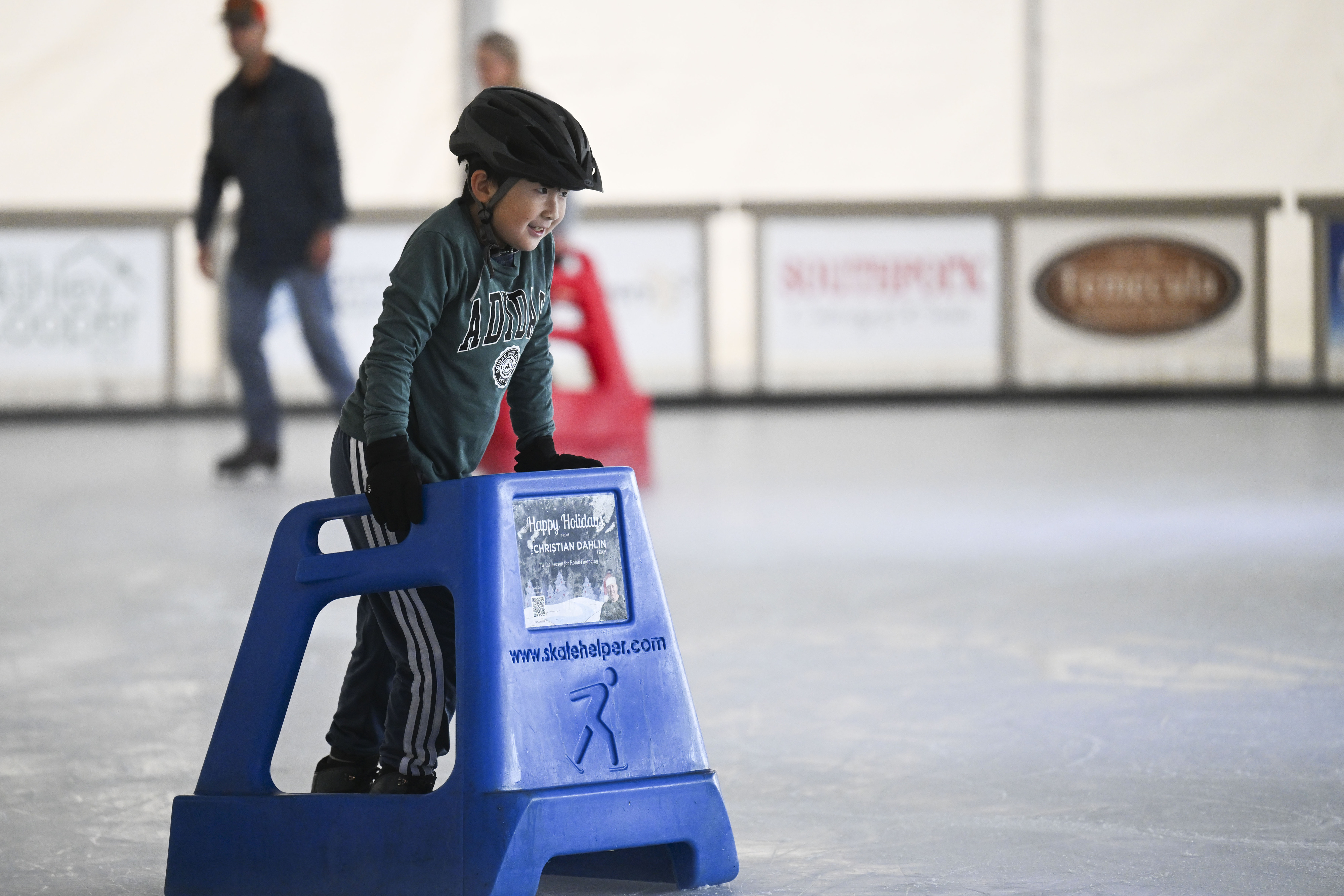 Kevin Young smiles as he skates around the ice rink...