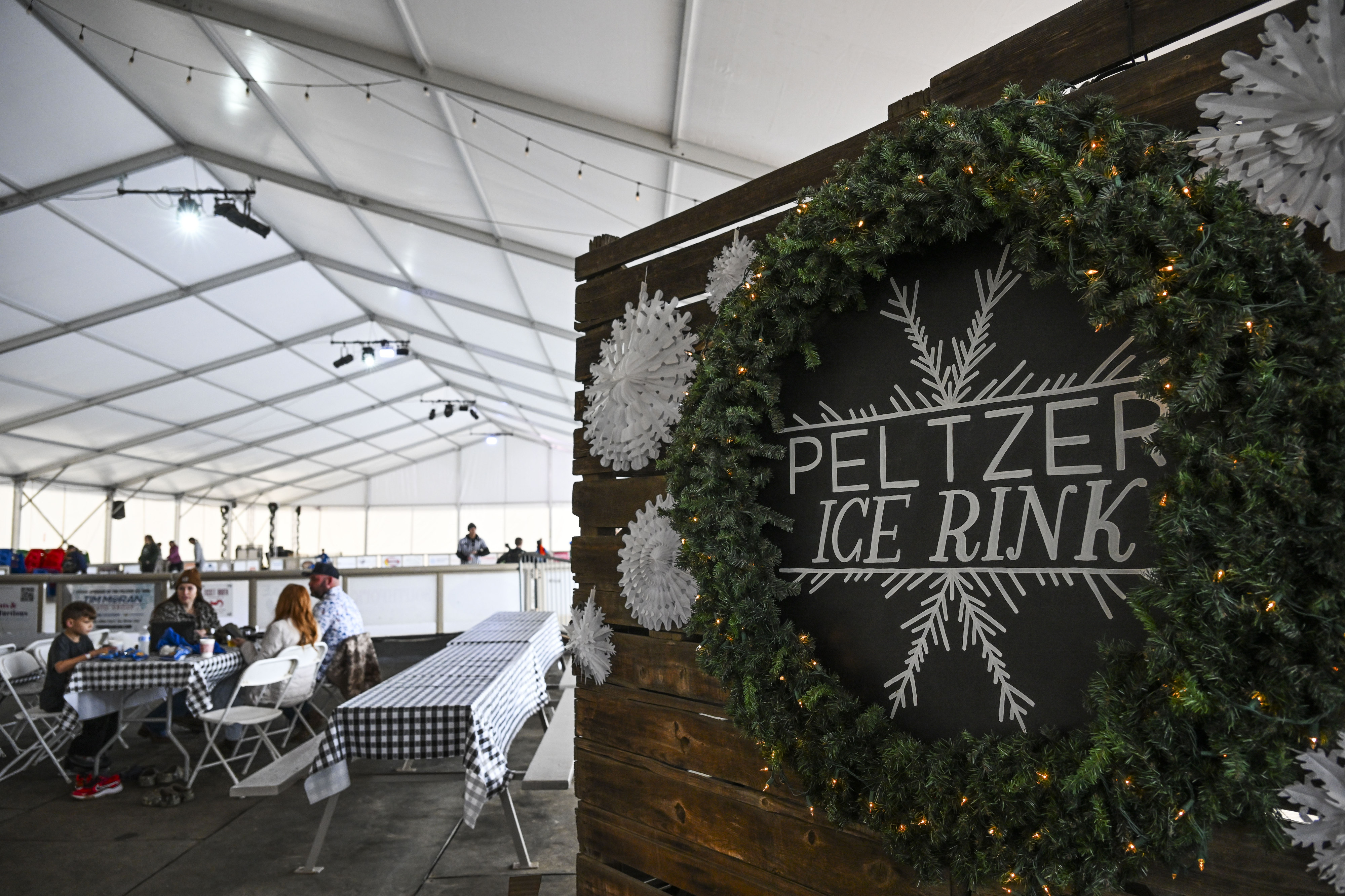 Children and adults enjoy the ice rink at Peltzer Winery...