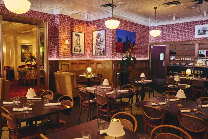 Dark red dining room at Red Rooster in NYC
