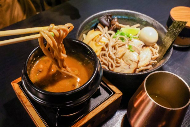 Tsukira Ramen owner Carol Chou dips noodles into a bowl of broth as part of an atsukemen-style ramen dish at her restaurant in Foster City, Calif., on Thursday, Jan. 8, 2026. (Ray Chavez/Bay Area News Group)