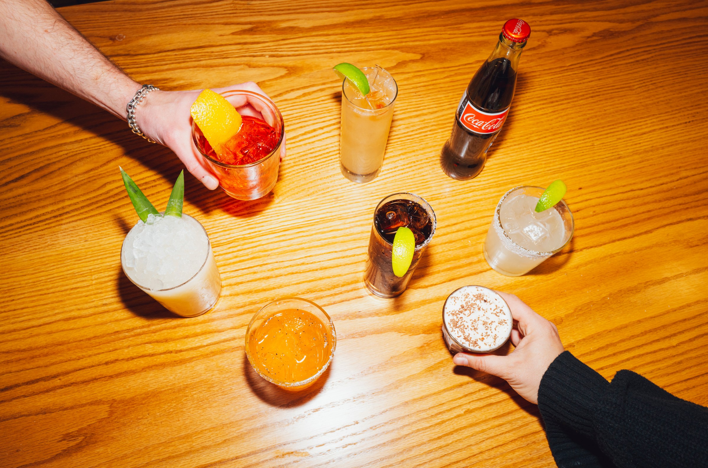 A bunch of cocktails and drinks on a table.