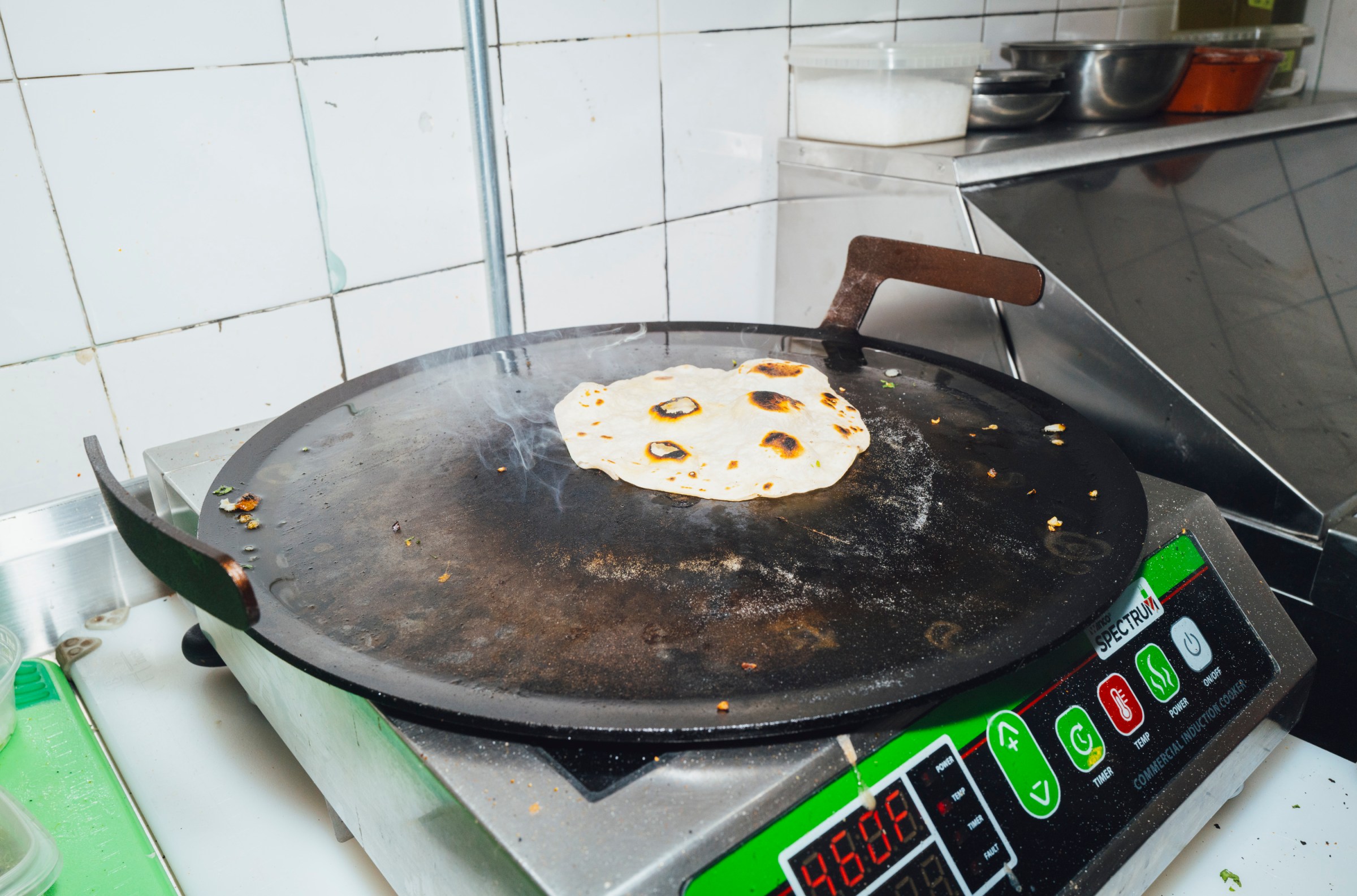 A tortilla on a griddle pan.