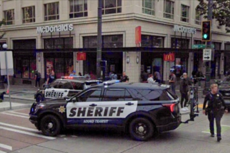 A McDonald’s in downtown Seattle has banned indoor dining by barring the doors and creating an improvised takeout window