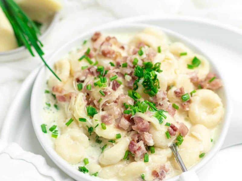 Gnocchi with Bacon and Cream Sauce served on a white plate.