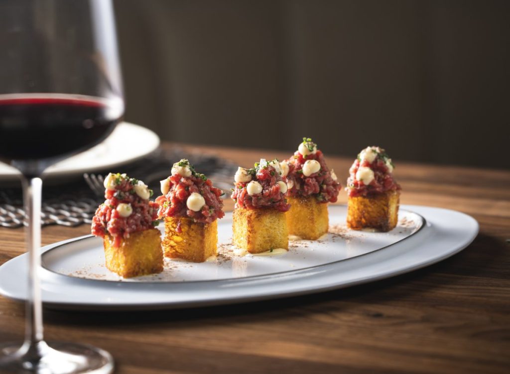 A plate of steak tartare on toast.