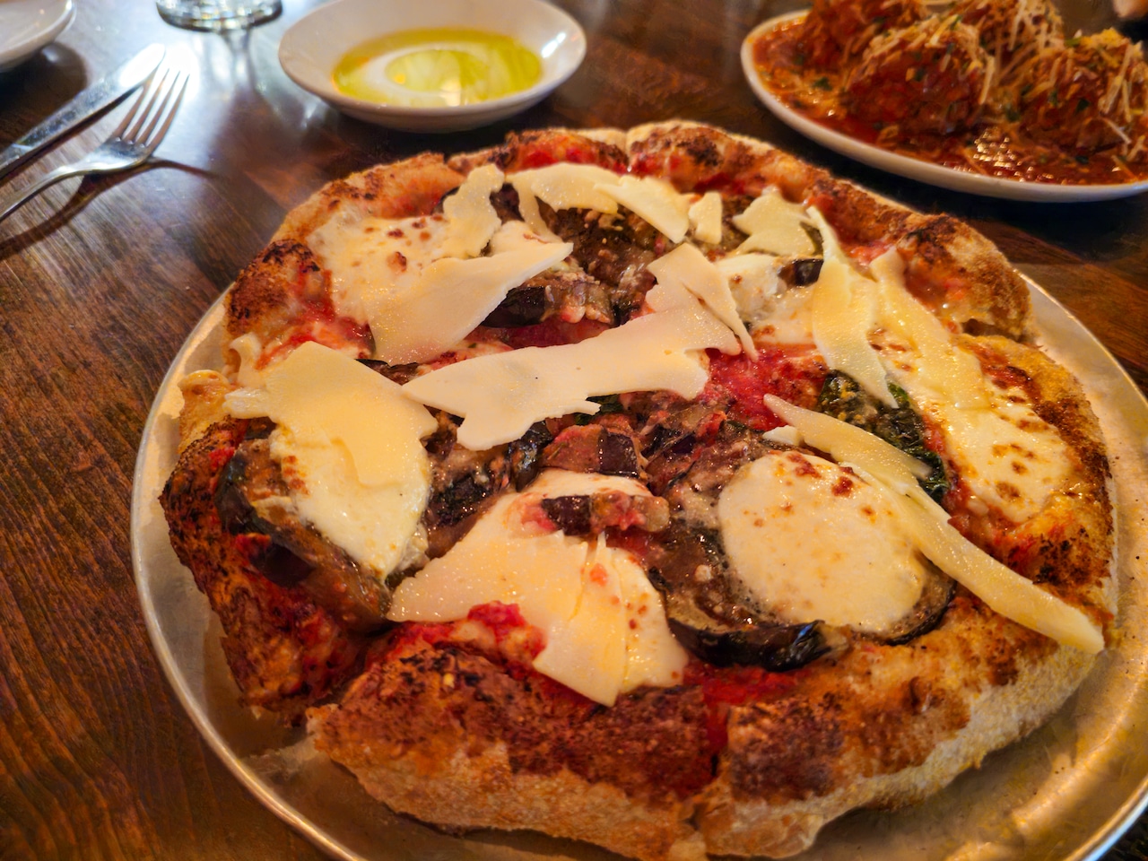 A pizza topped with eggplant and cheese.