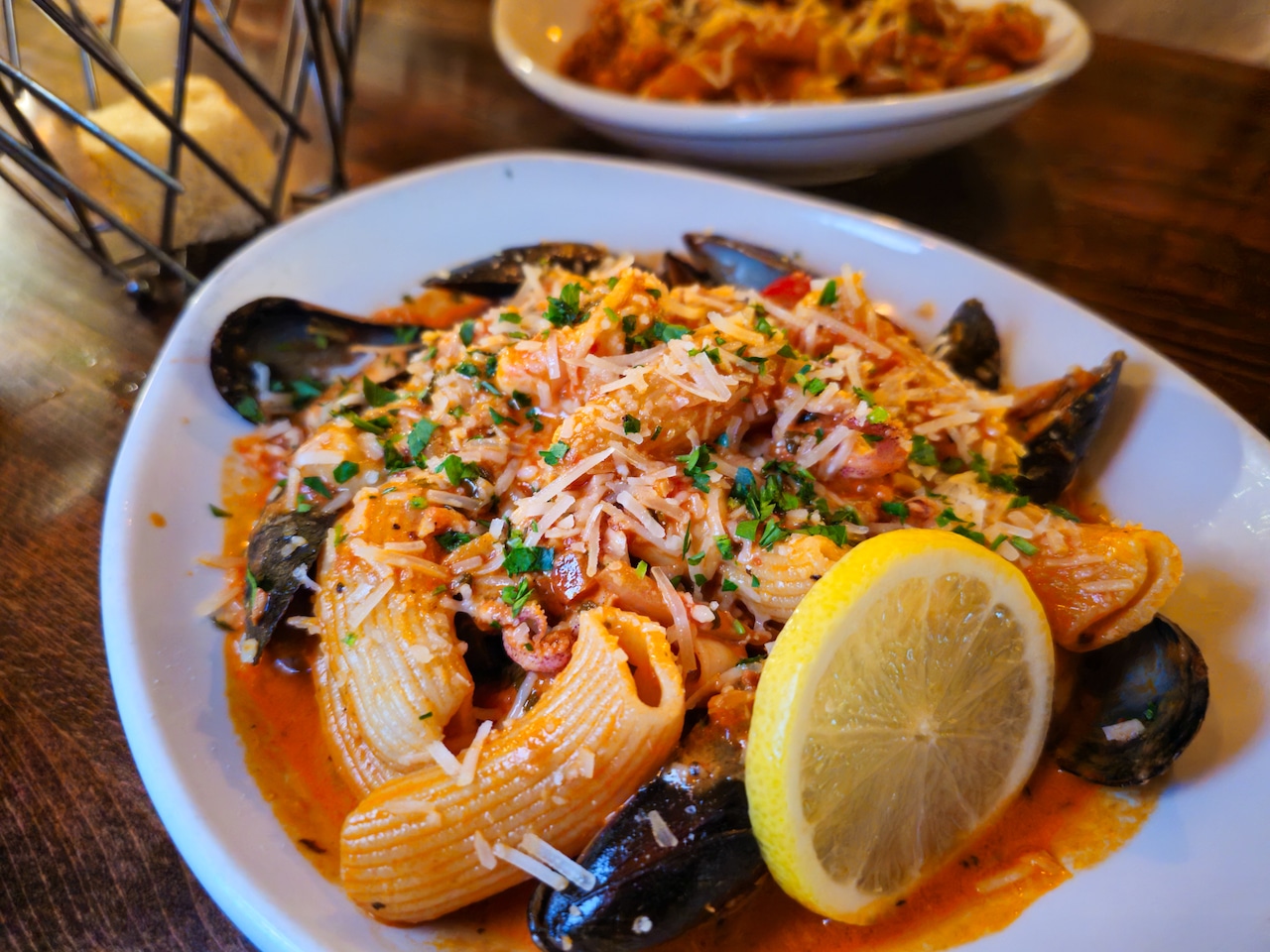A plate of pasta with seafood.