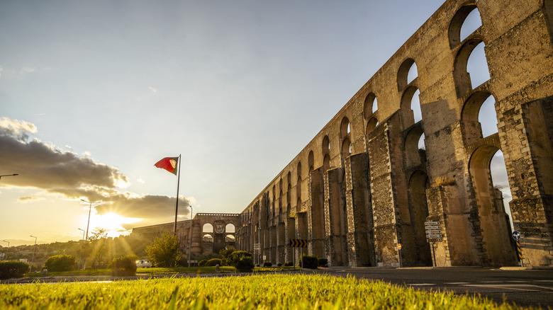 The Amoreira Aqueduct seen at sunset
