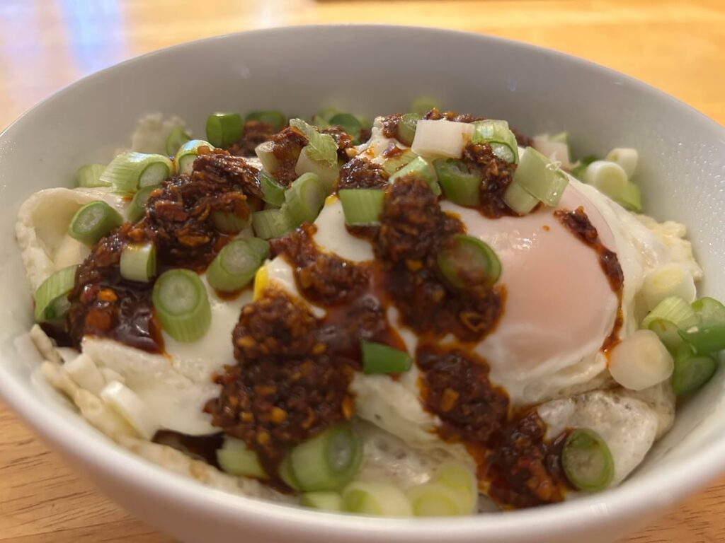 Fried egg rice bowl with chili crisp and green onion