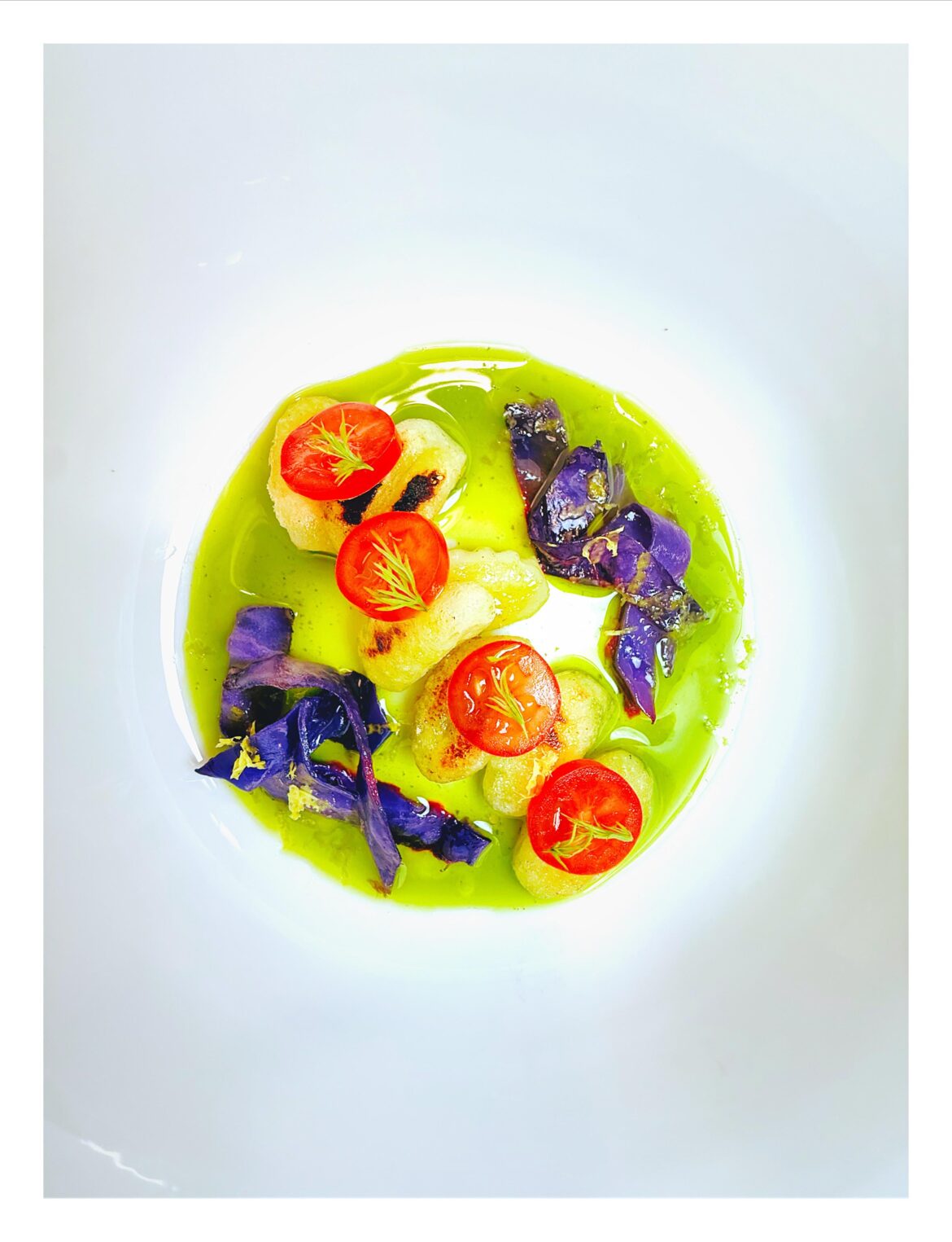 Crispy gnocchi, sautéed purple cabbage, grape tomato, lemon basil oil