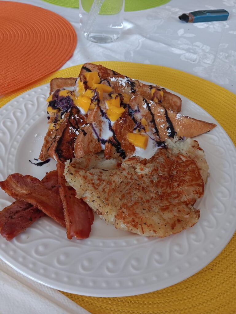 Ube flavored French toast topped with mango and sweet cream.