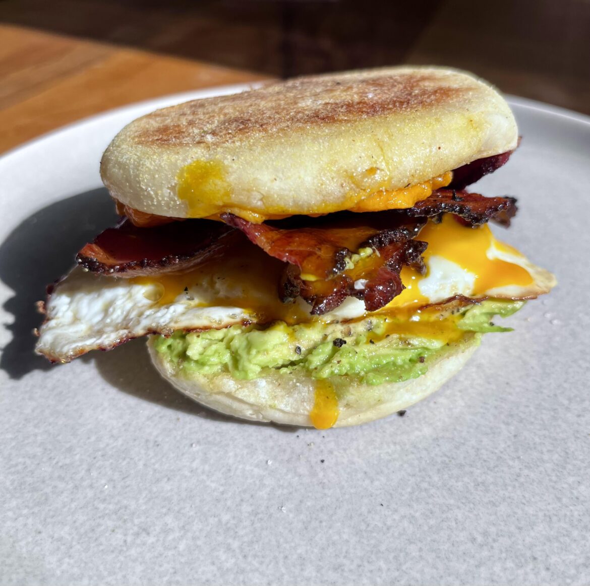 [homemade] “McMuffin” - bacon, runny egg, aged cheddar, avocado