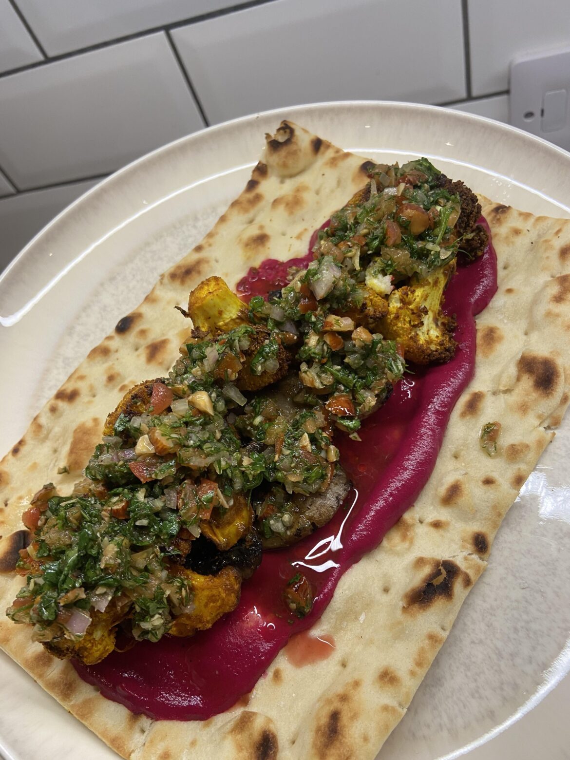 Spiced Cauliflower & Mushroom Levantine Wrap, with beetroot hummus, and a chopped herb salad.