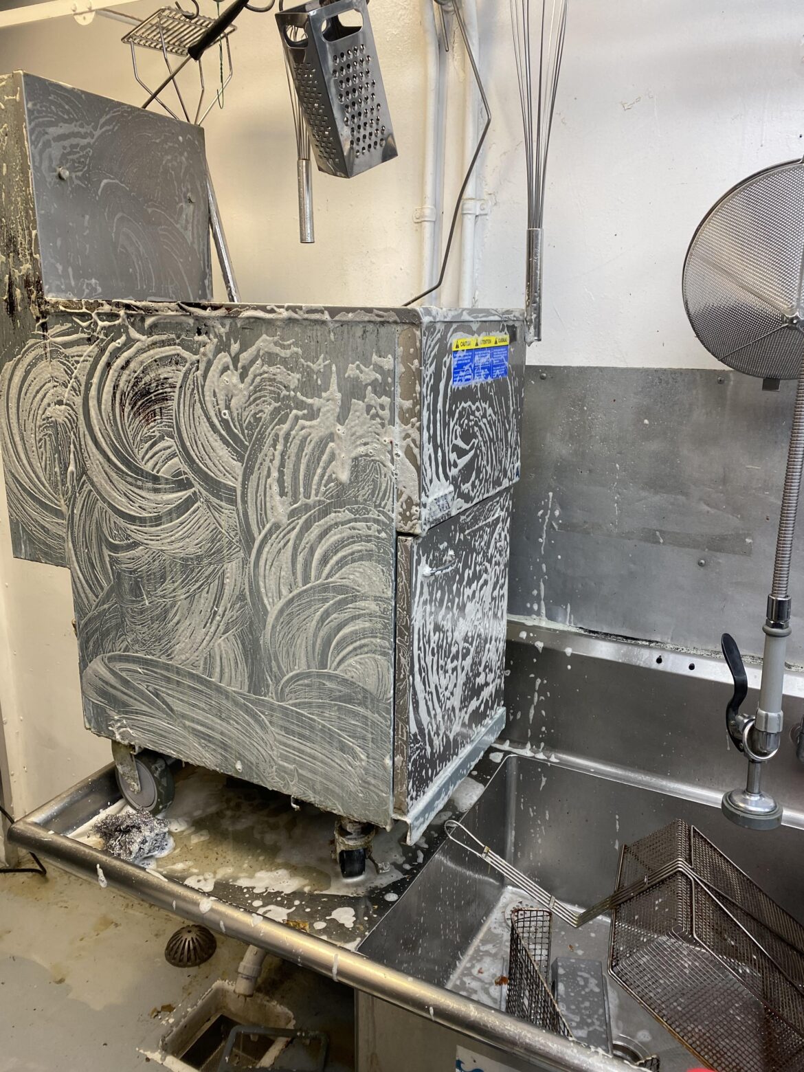 Does the fryer go into the sanitizing solution or should I just pour it on top?