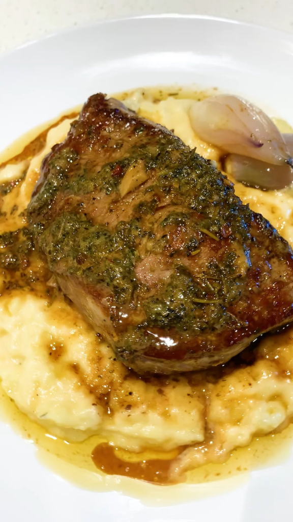 Pan-Seared Steak with Bone Marrow Herb Butter & Roasted Shallots on Creamy Mashed Potatoes