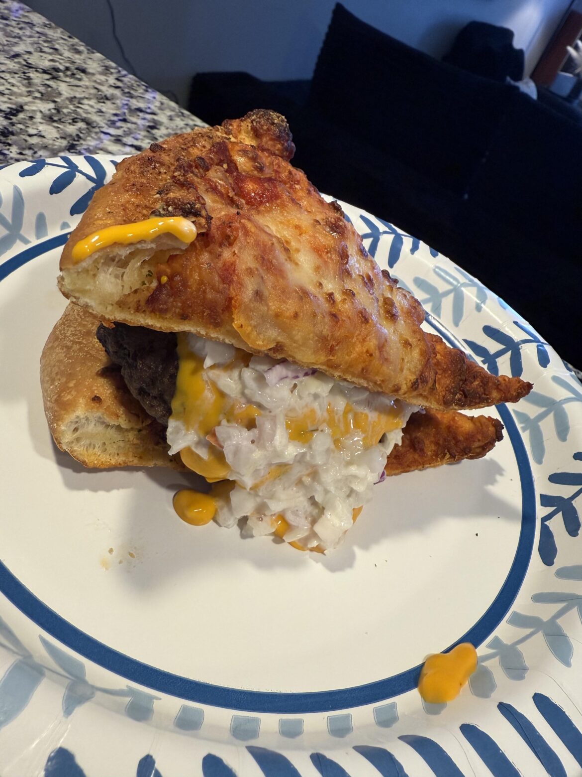 Nacho cheeseburger…..pizza…..thing. (Crime: Using pizza slices as hamburger buns)
