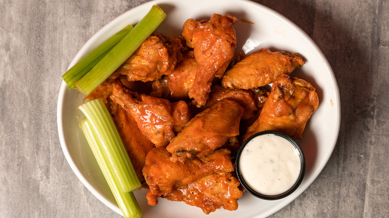 Plate of Buffalo wings with celery