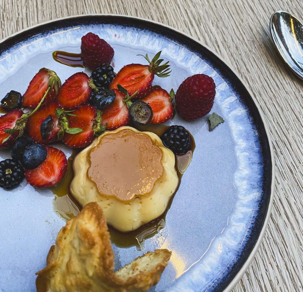 creme caramel and fruit on a plate, french dessert