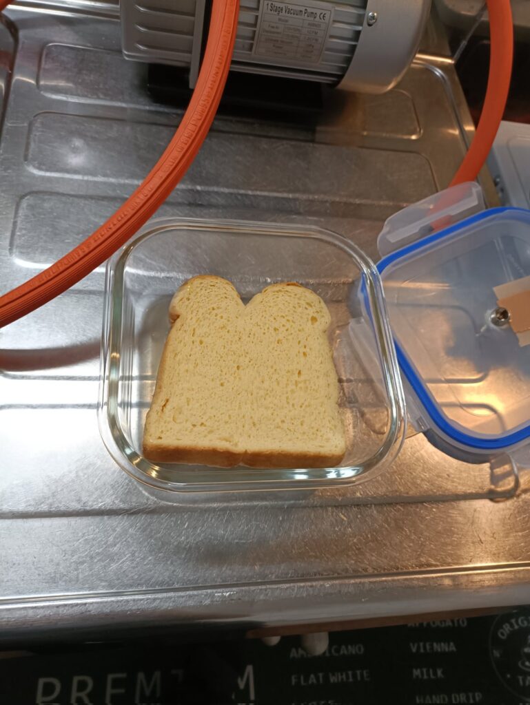 Soaks bread in egg mixture in vacuum about a minute to make French toast