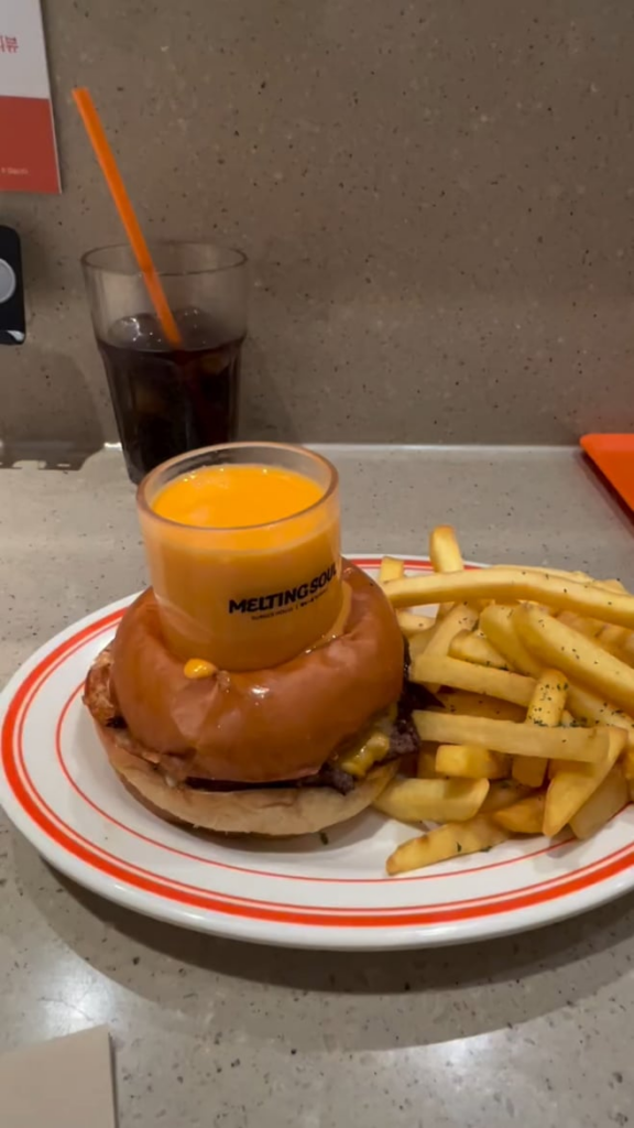 The overflowing cheese and a big ass hole in the burger