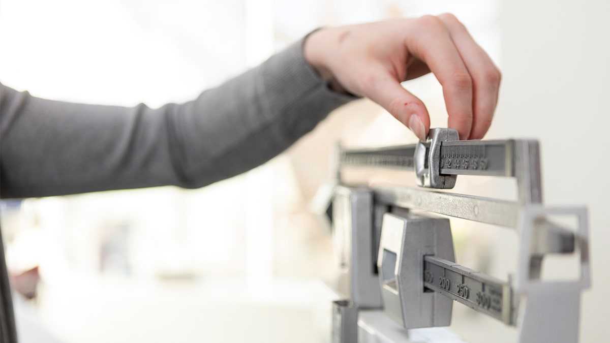 Woman weighing herself