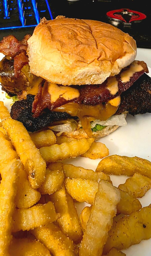 Jerk chicken breast sandwich with cheddar, bacon, and creamy sriracha sauce