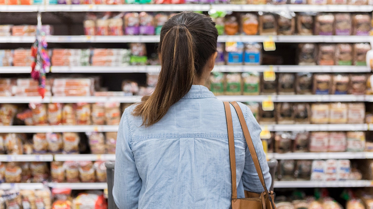 Woman looking at bread aisle