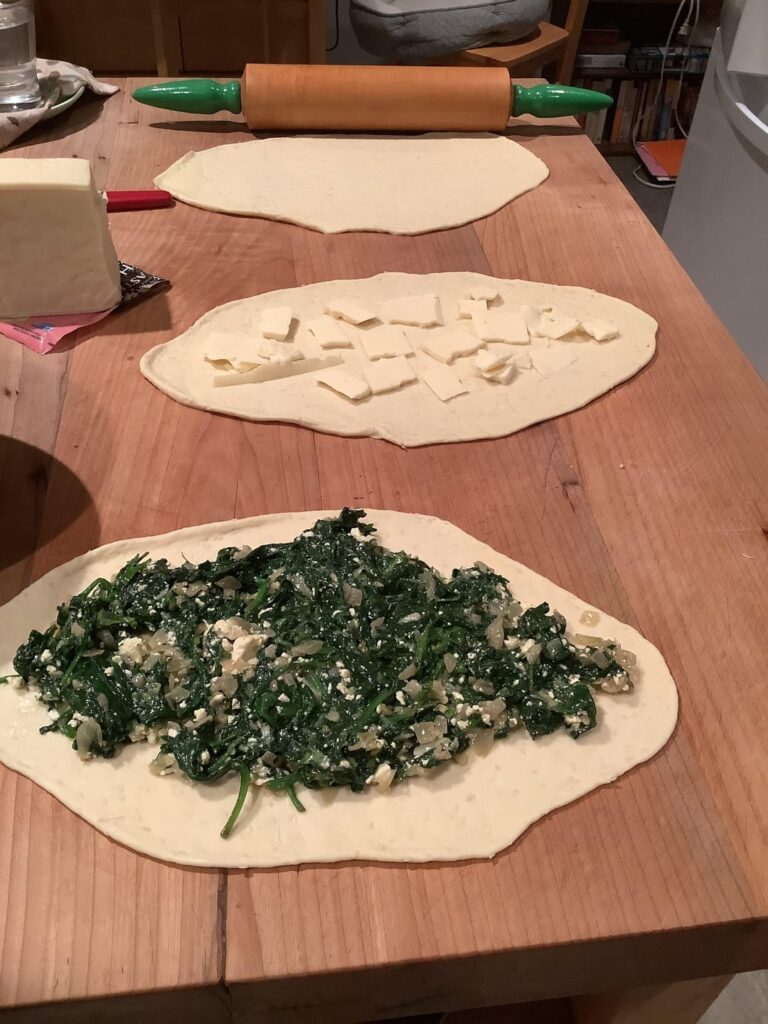 First time making vegetarian Pide. Instead of lamb, spiced lentils, v . Spinach feta v.garlic butter, roasted peppers and olives.  Minted yogurt to accompany.