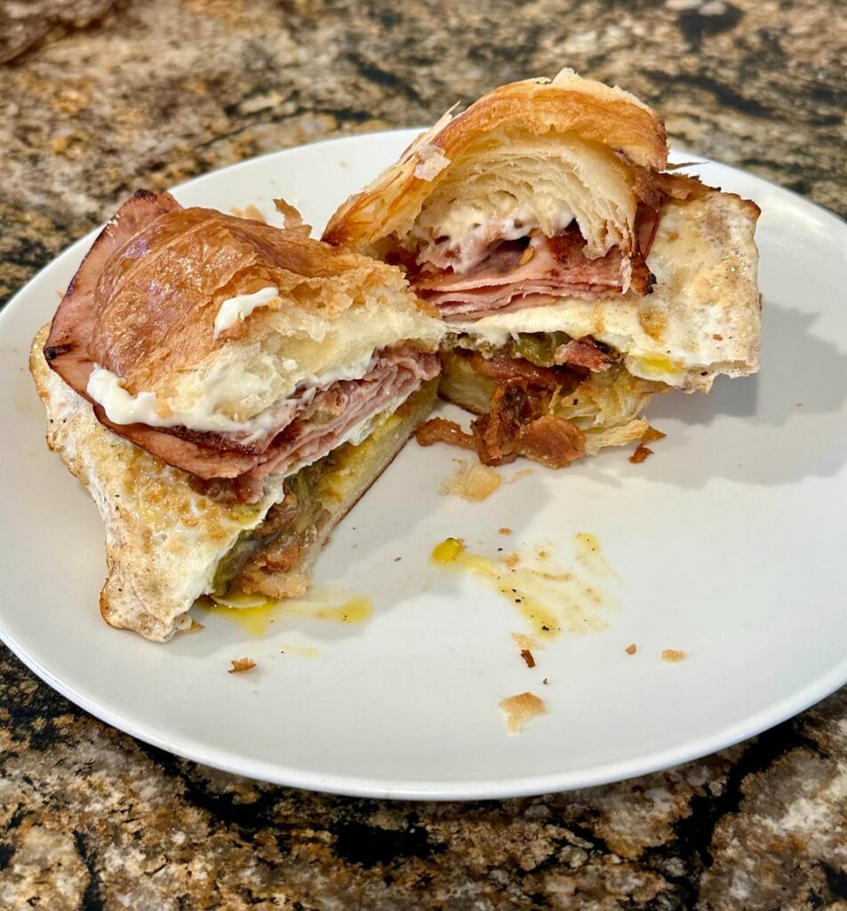 Grilled Ham, Bacon, NM Green Chile, and Fried Egg on Toasted Croissant
