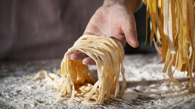 Hand holding homemade pasta