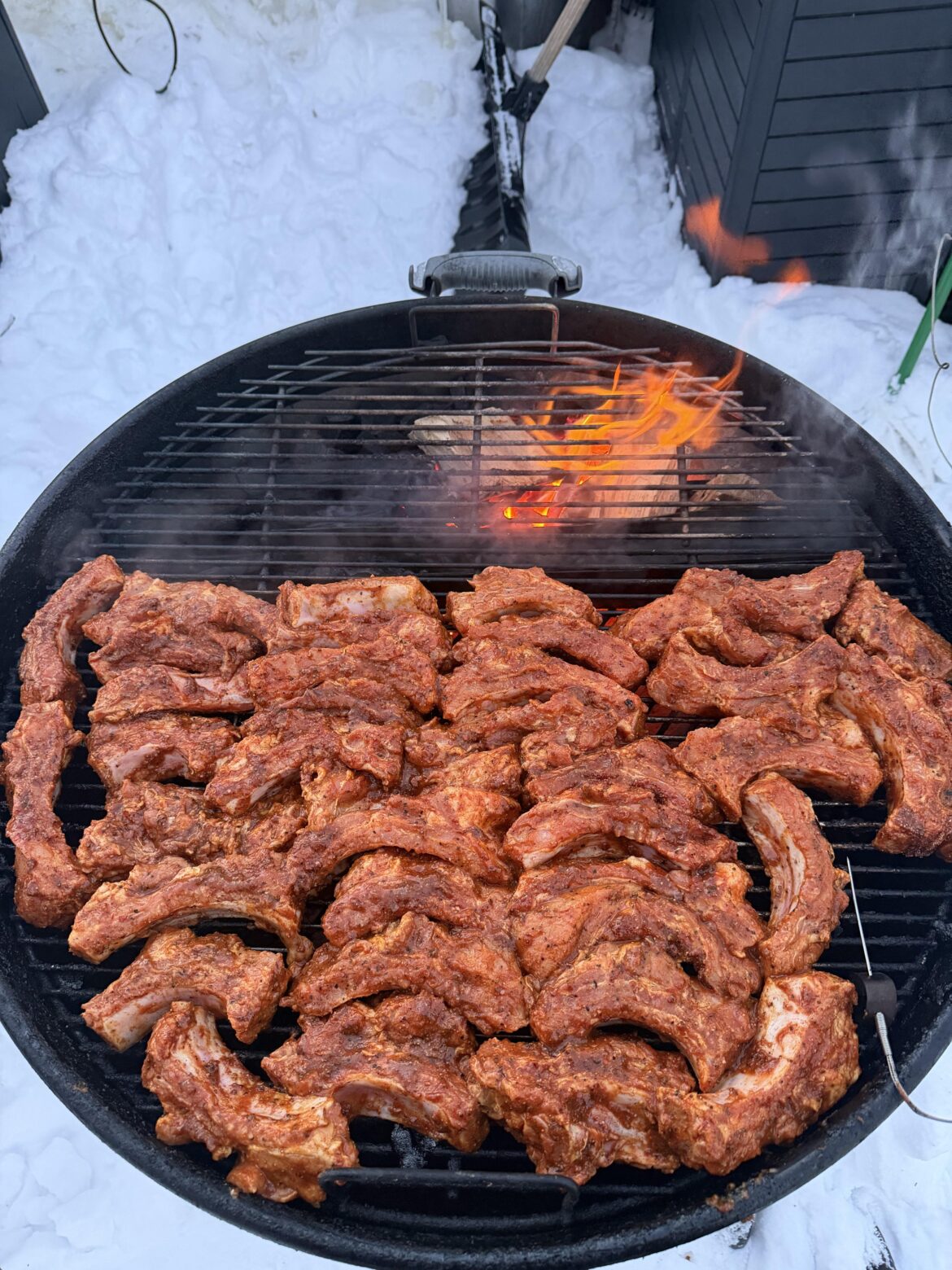 The Weber Kettle can fit three racks of party ribs.