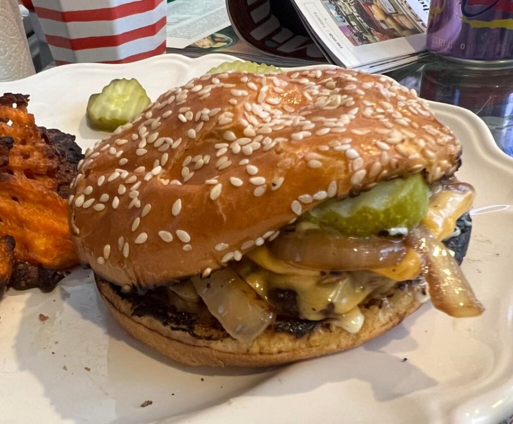 Not pretty, but juicy, basic cheeseburgers with American cheese, pickles and grilled onions.