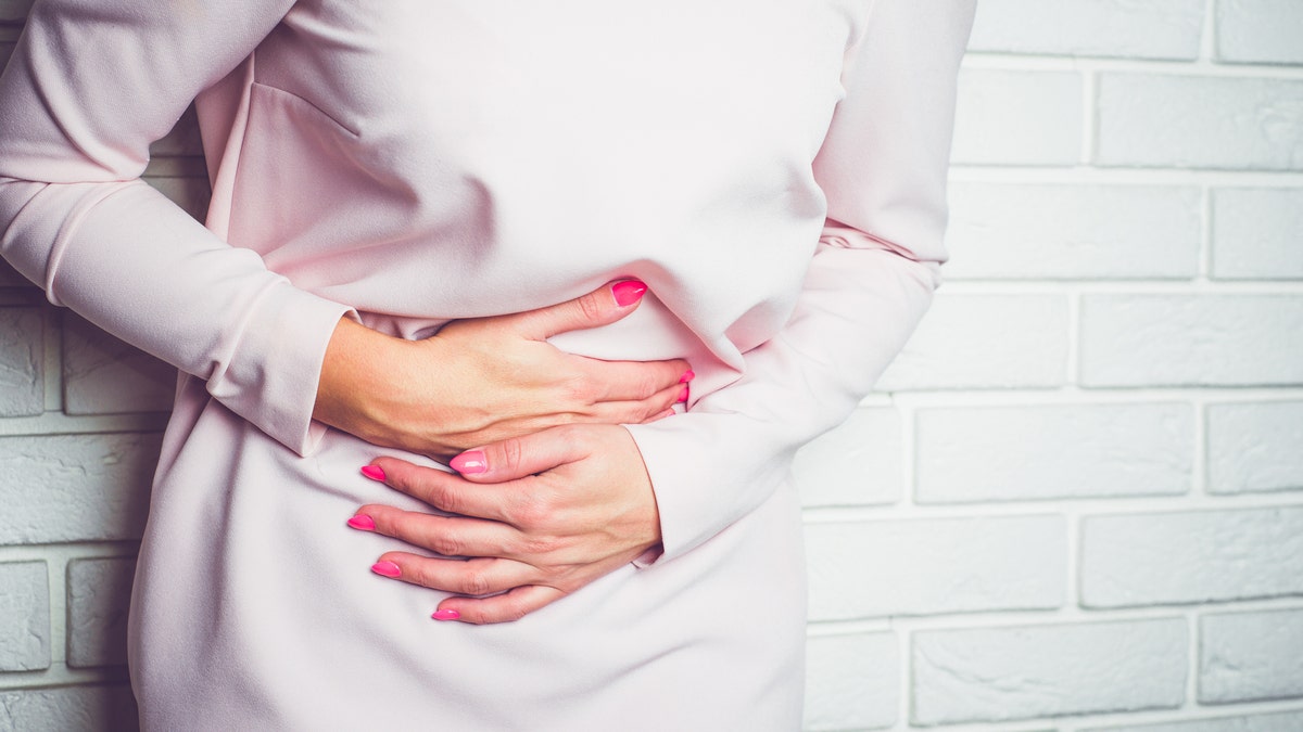 Woman holds hurt stomach