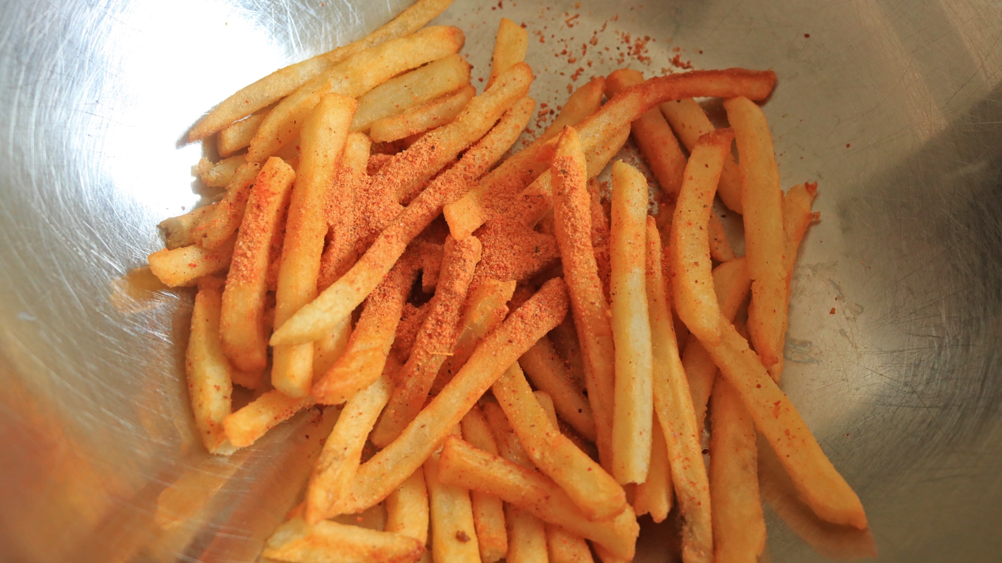 French fries with a red powder tossed on top.