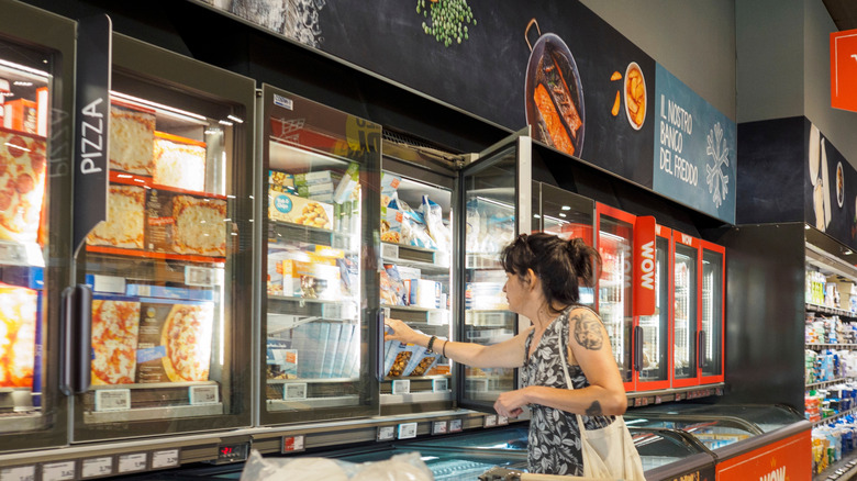 person shopping in Aldi's frozen food case